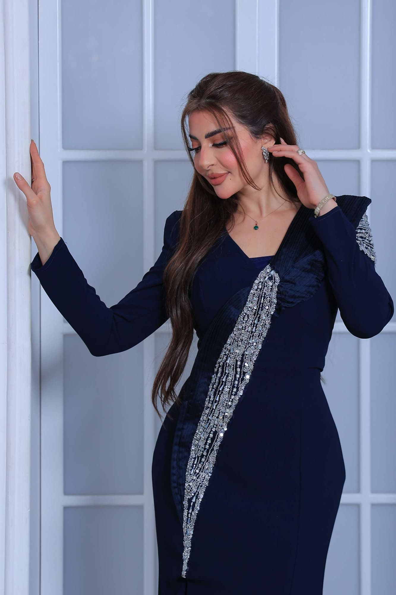 فستان سهرة طويل يتميز بقصّة مستقيمة تبرز القوام بانسيابية يعكس فخامة هادئة وأناقة عصرية.