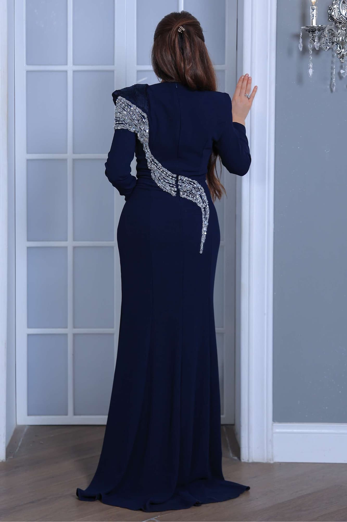 فستان سهرة طويل يتميز بقصّة مستقيمة تبرز القوام بانسيابية يعكس فخامة هادئة وأناقة عصرية.