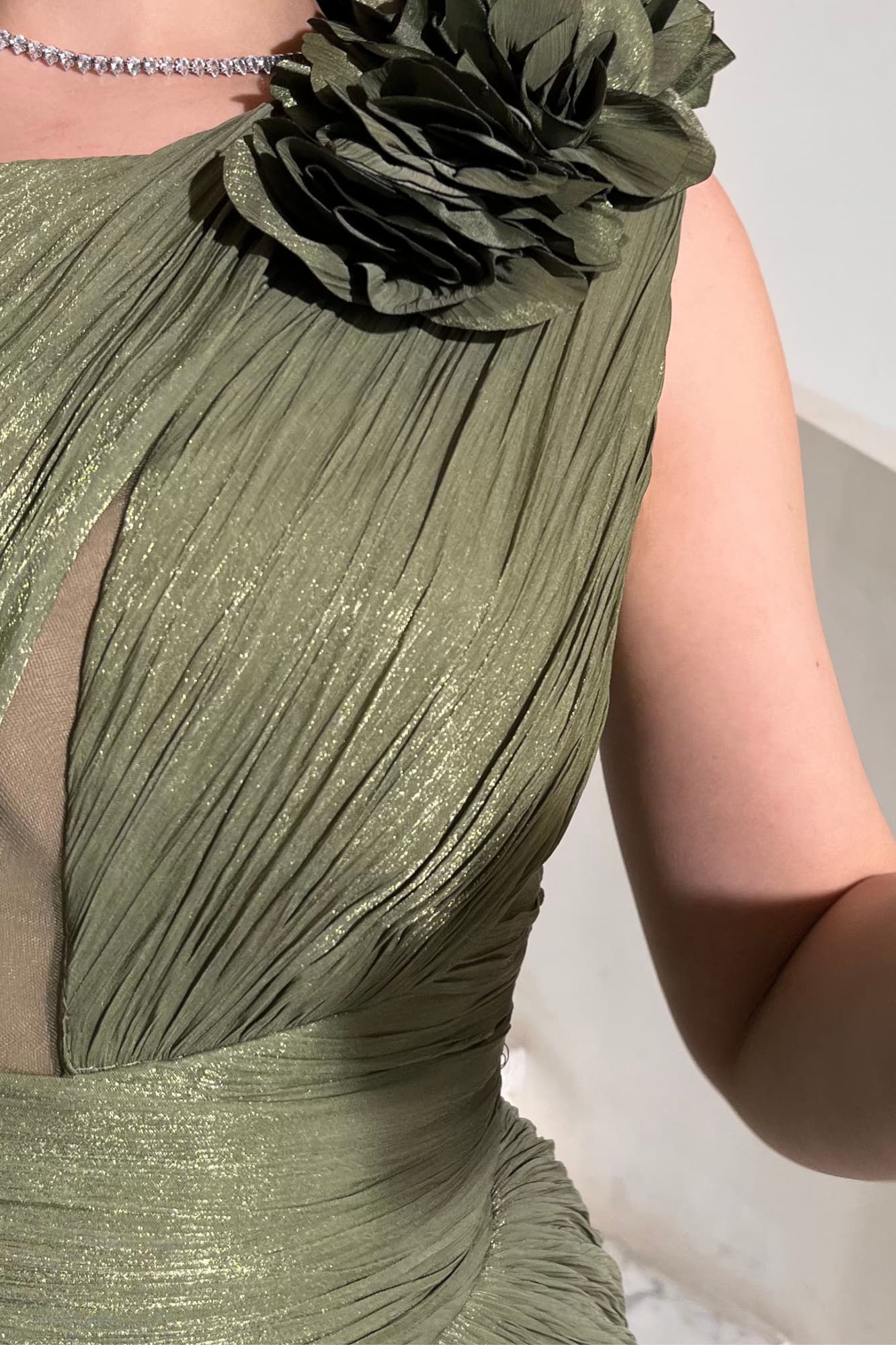 فستان سهرة مصمم بقماش مطوي بالكامل بطريقة فنية تعطي انسيابية وتناسق مثالي مع القوام زيتي فاتح