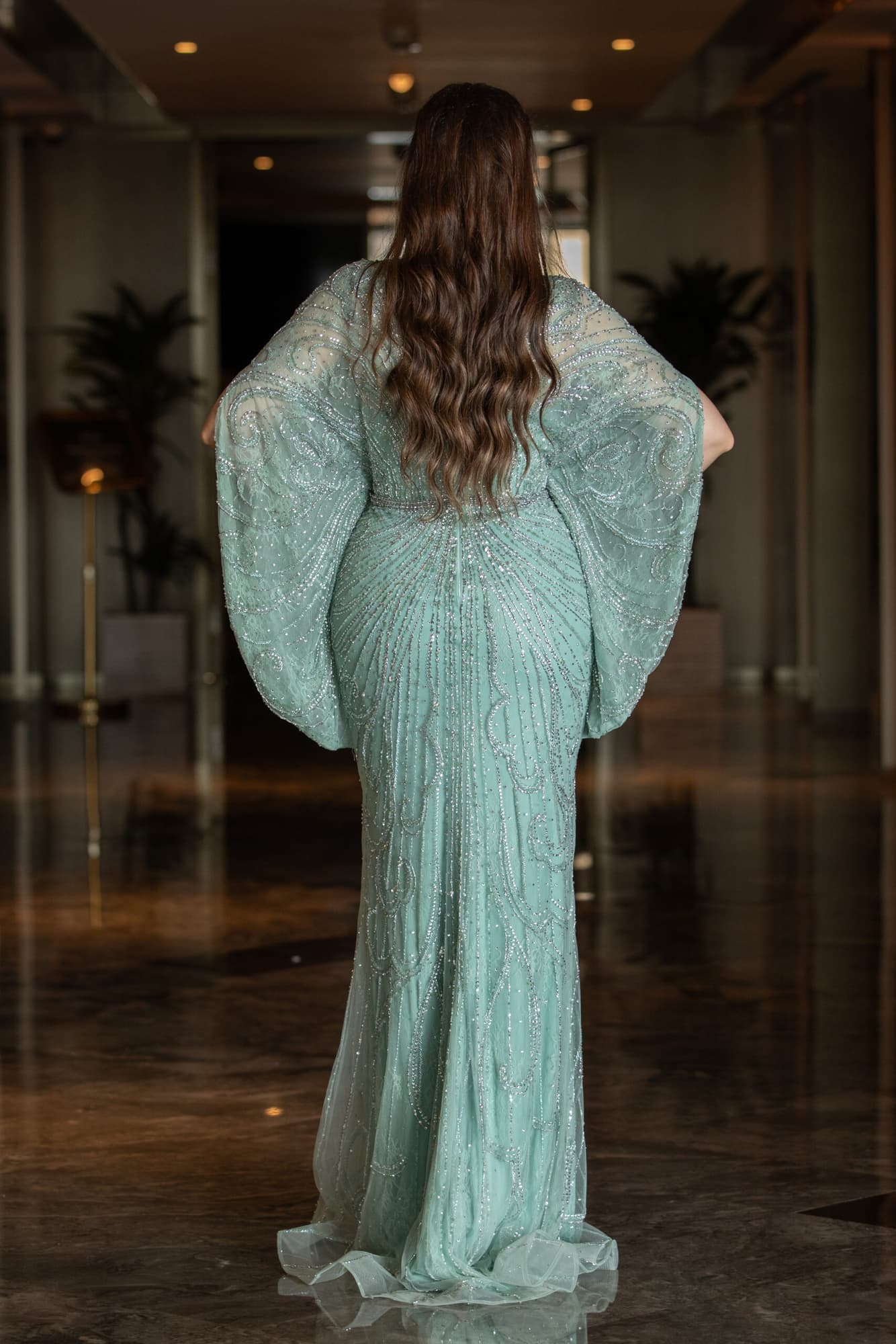 فستان طويل بفتحه ساق صمم باكمام واسعة منبسطة