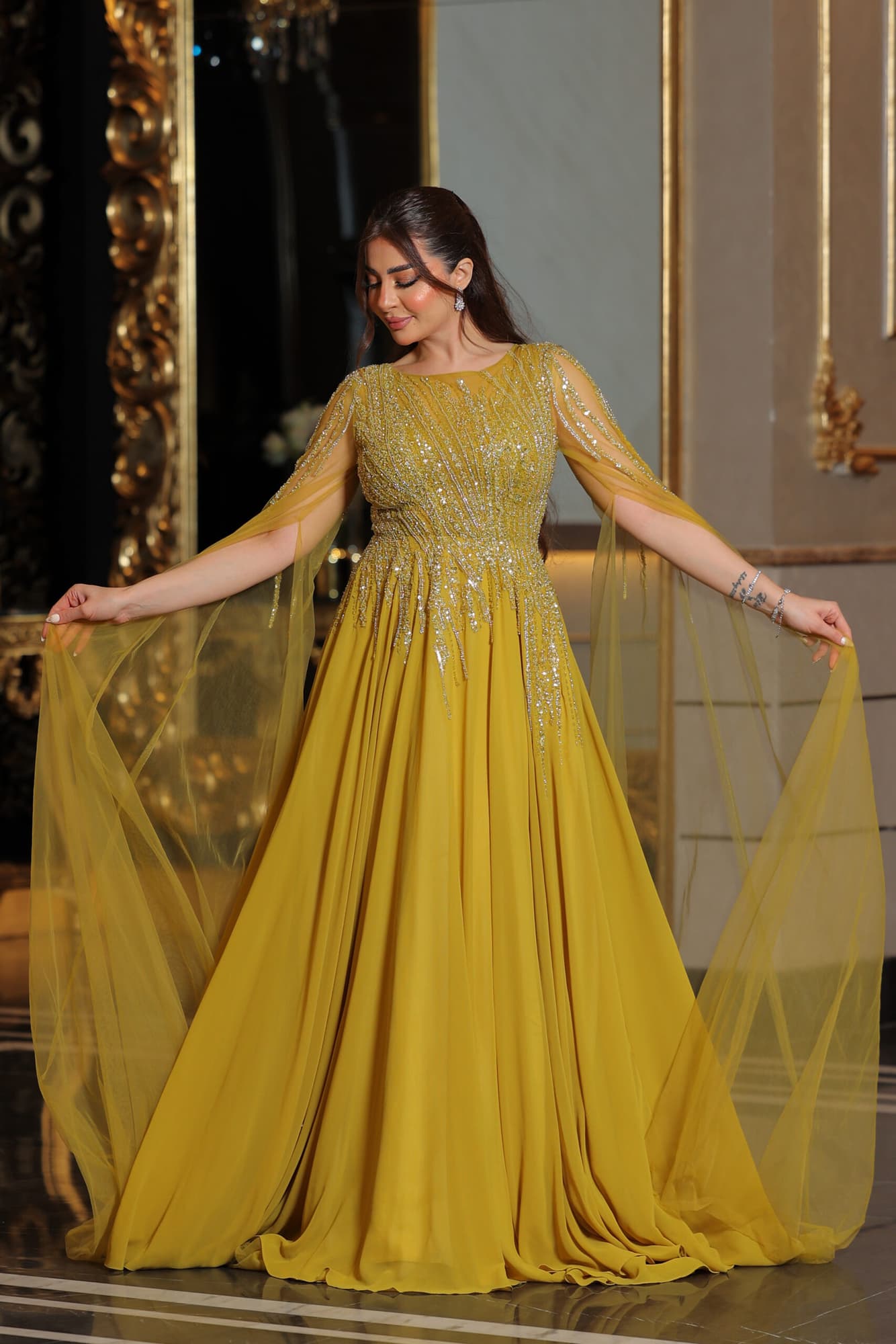 فستان سهره كلوش مطرز باكمام كيب منسدله كموني