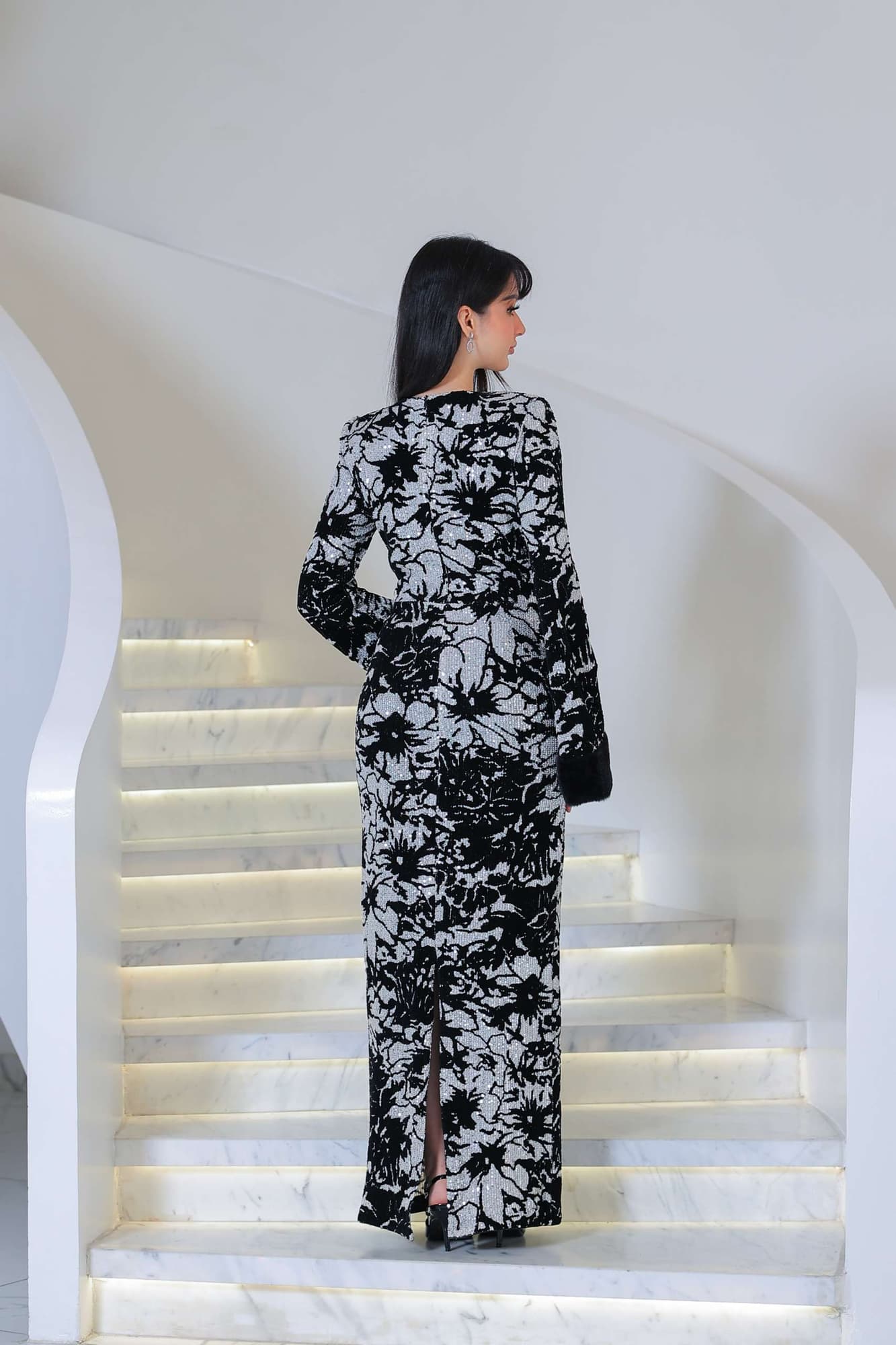 فستان أنيق بطابع راقٍ، يجمع بين اللون الأسود العميق ونقشات فضية مستوحاة من الزهور