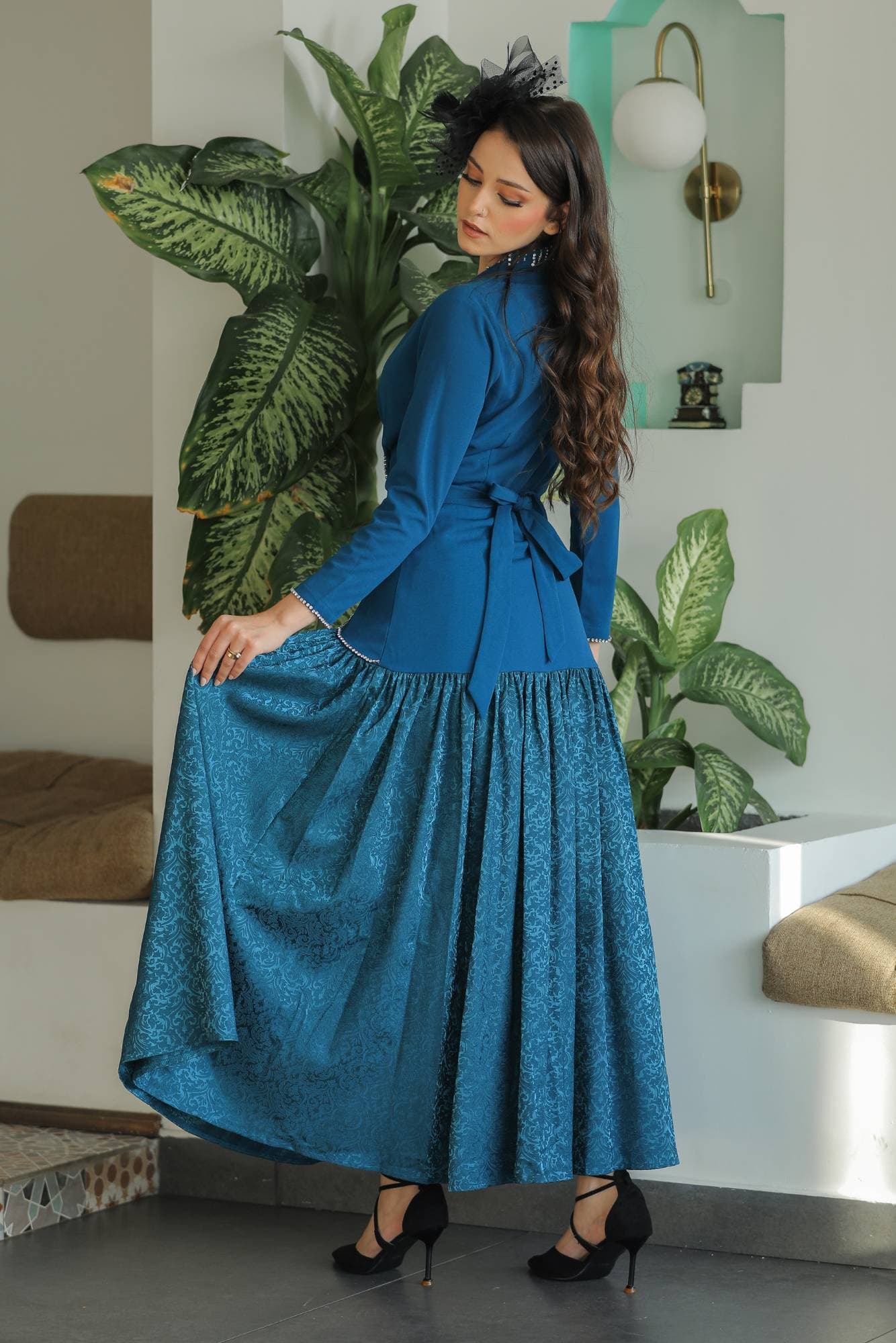 فستان راقٍ بلون أخضر زمردي عميق يجمع بين الكلاسيكية والفخامة بأسلوب عصري